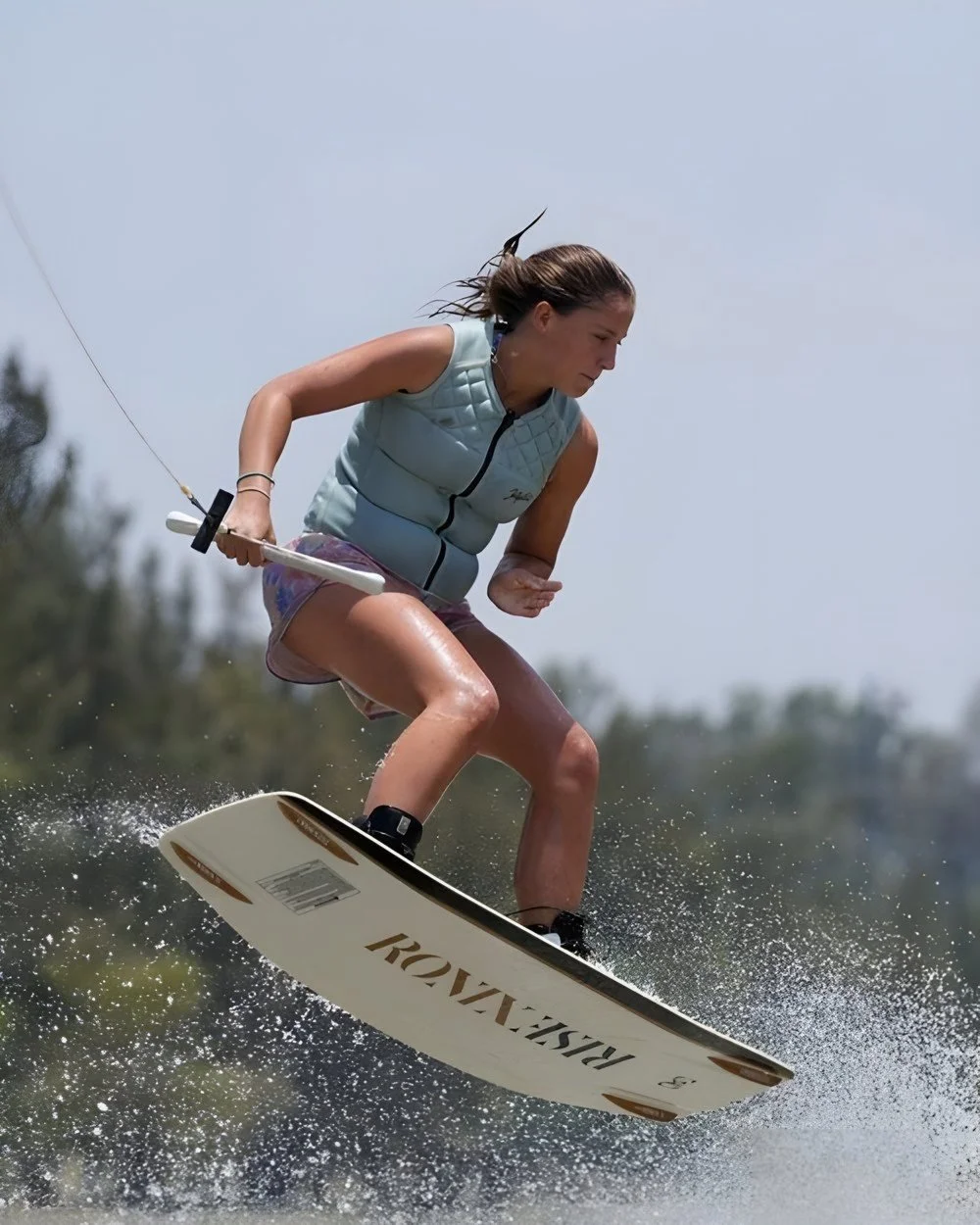 Fernanda Larios carving behind the boat