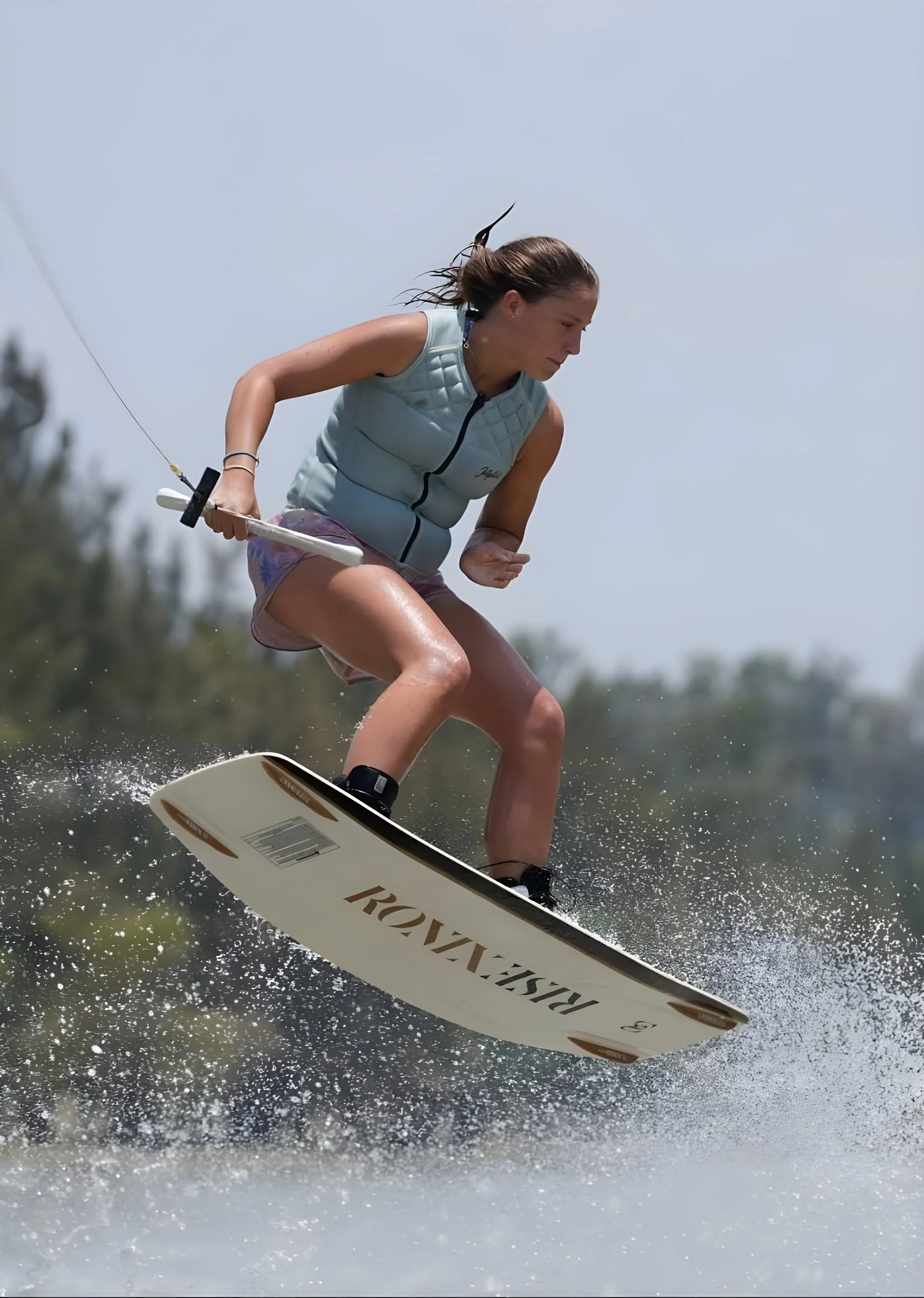 Fernanda Larios carving behind the boat