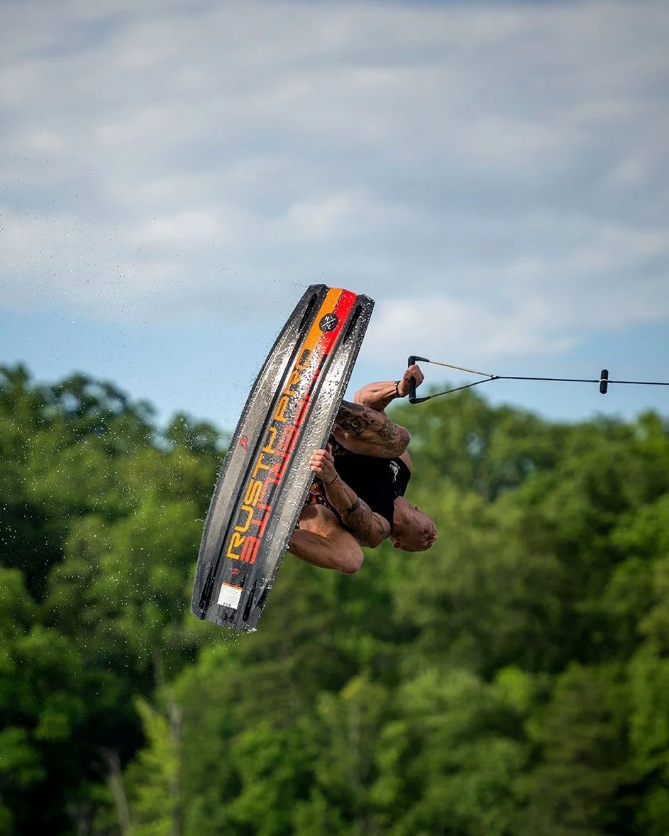 Rusty Malinoski inverted, his signature board overhead