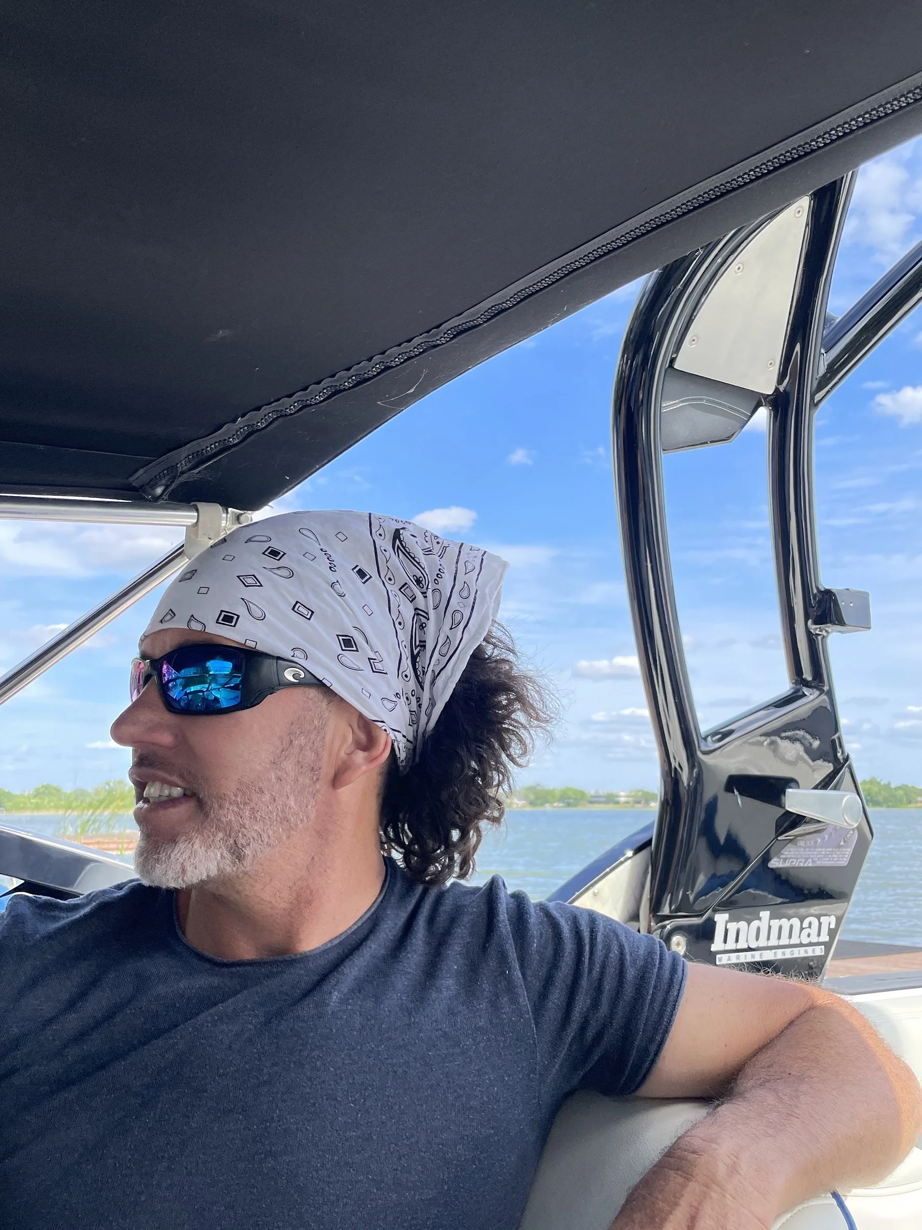 Glen driving the boat, looking back toward his rider