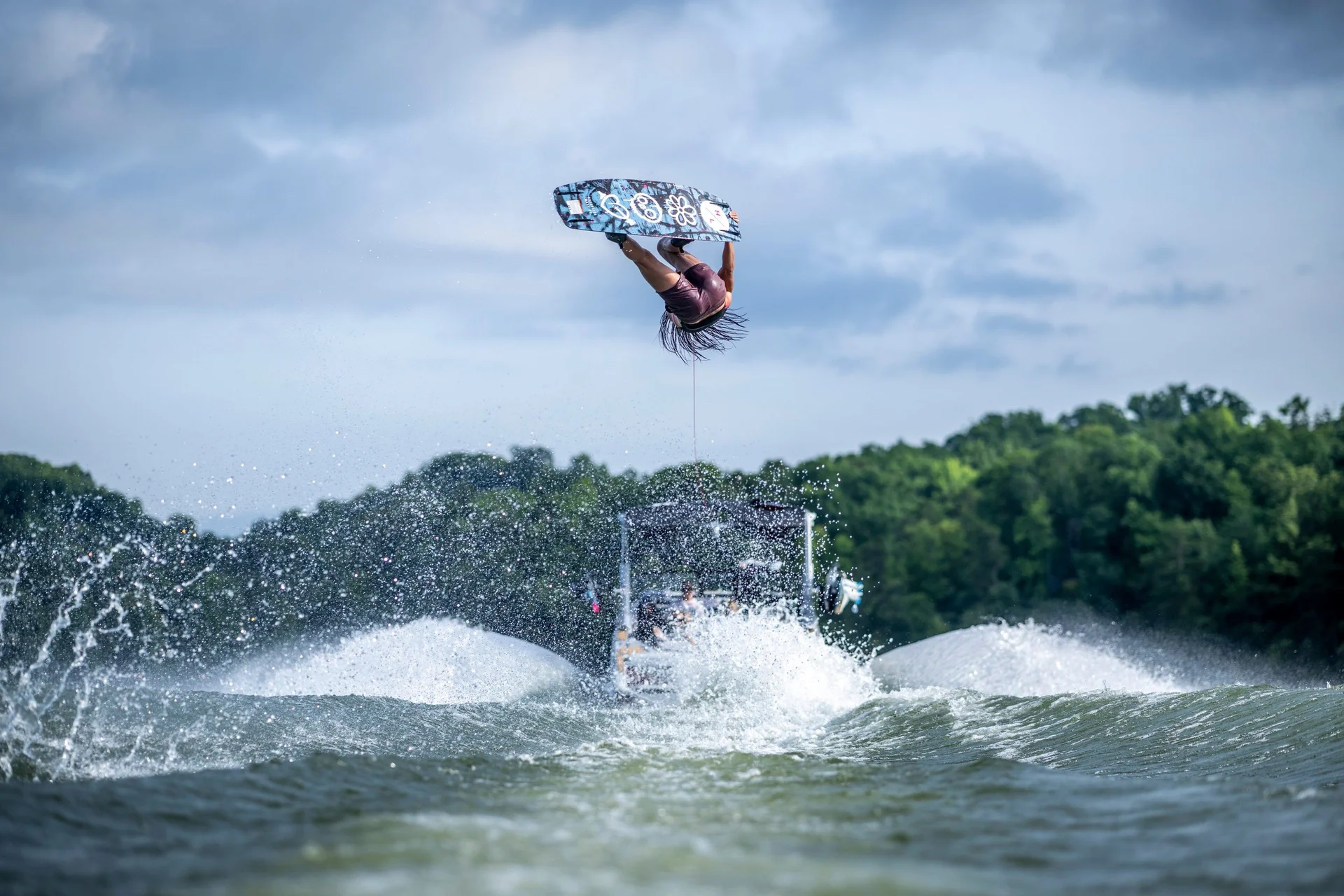 A rider fully inverted high above the boat