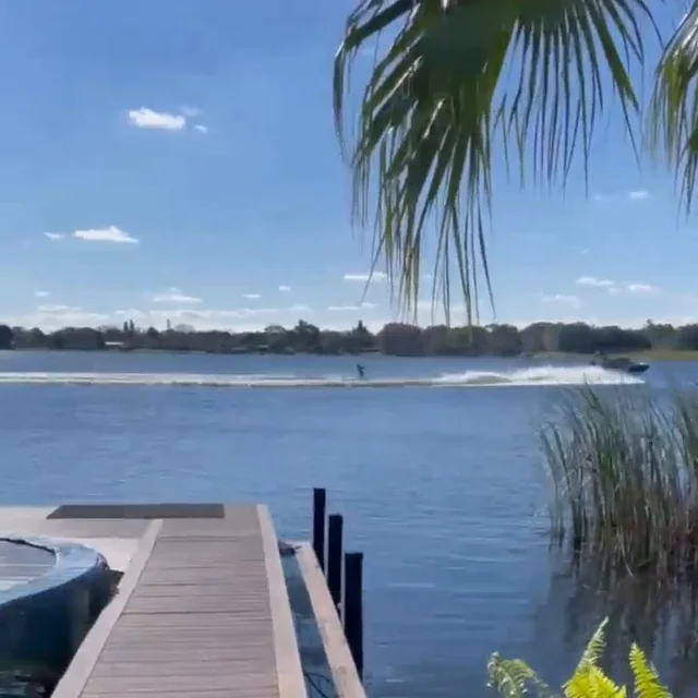 Palm trees opening onto the dock and Lake Barton